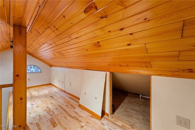 additional living space featuring vaulted ceiling, wood ceiling, and light hardwood / wood-style flooring