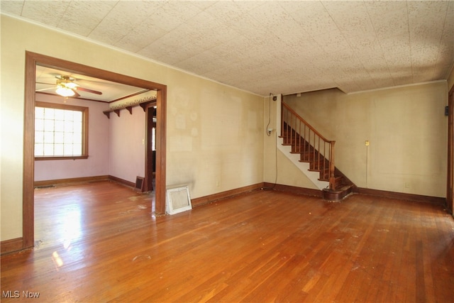 unfurnished room featuring hardwood / wood-style flooring and ceiling fan