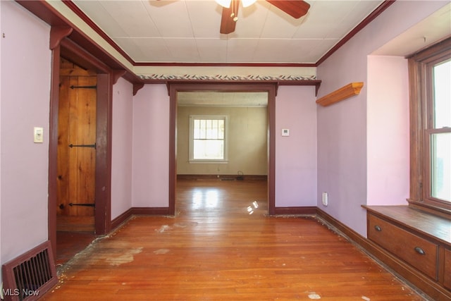 hall featuring light hardwood / wood-style floors and crown molding