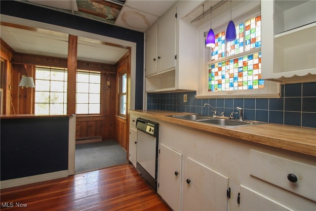 kitchen featuring tasteful backsplash, dishwasher, dark hardwood / wood-style flooring, hanging light fixtures, and white cabinetry