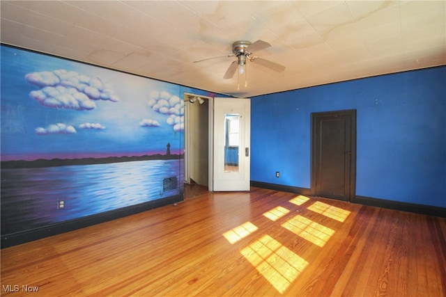 spare room featuring hardwood / wood-style flooring and ceiling fan