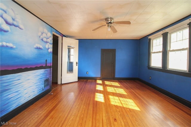 unfurnished room with ceiling fan and hardwood / wood-style floors