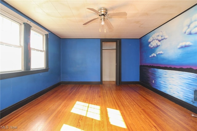 spare room featuring hardwood / wood-style flooring and ceiling fan