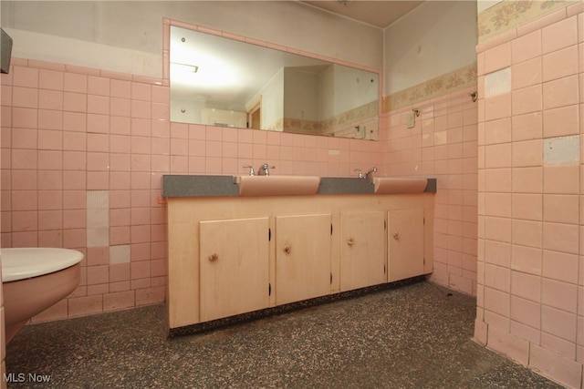 bathroom featuring vanity, toilet, and tile walls