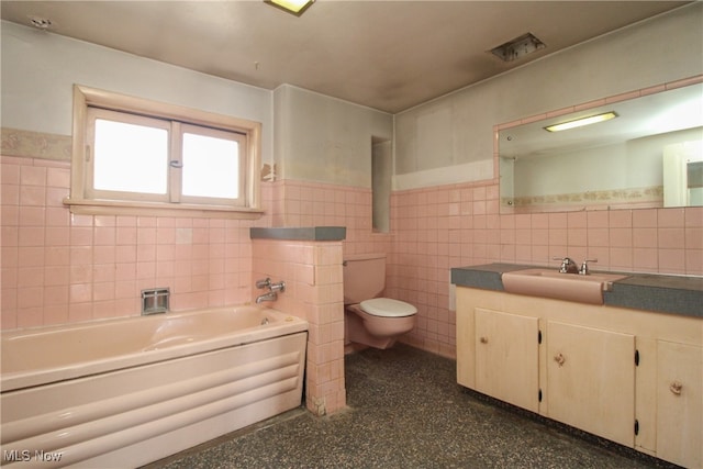 bathroom with vanity, toilet, tile walls, and a washtub