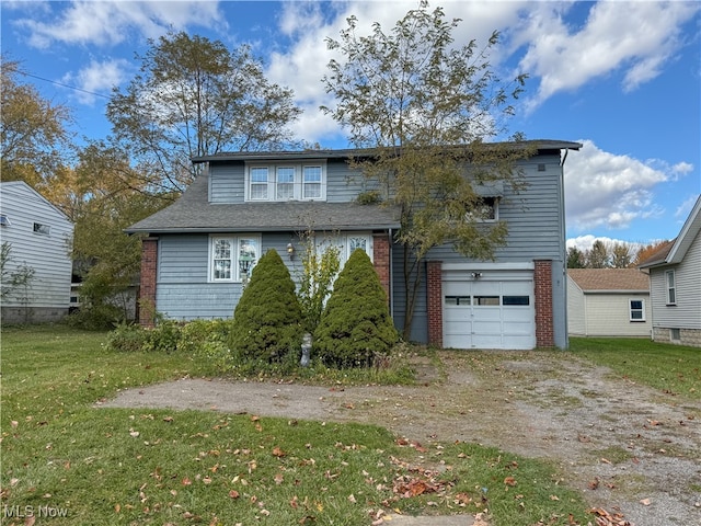 back of house with a garage and a lawn