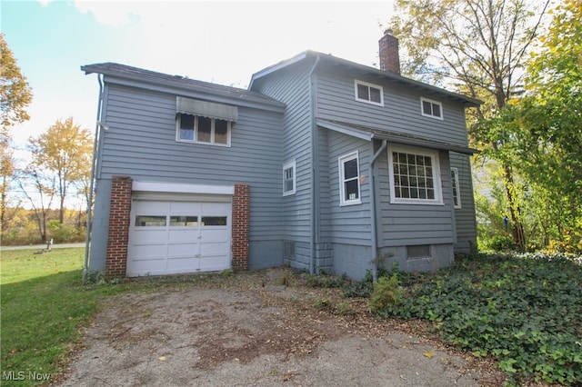 rear view of house with a garage