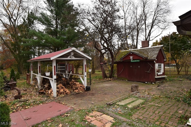 view of yard with a patio and an outbuilding