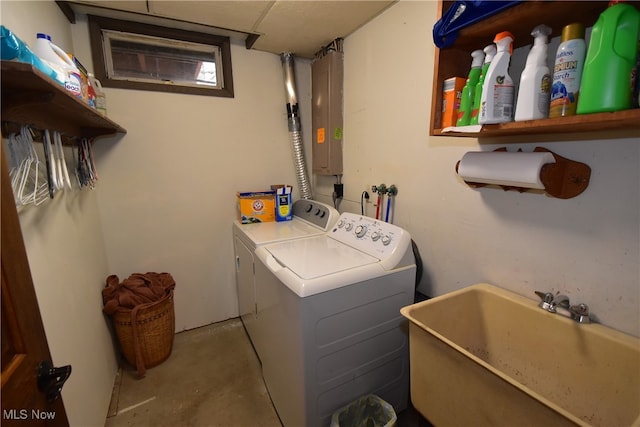 washroom featuring washer and dryer, electric panel, and sink