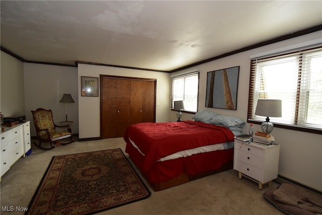 carpeted bedroom with ornamental molding, multiple windows, and a closet