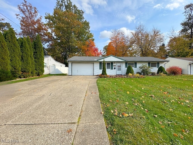 ranch-style house with a garage and a front lawn