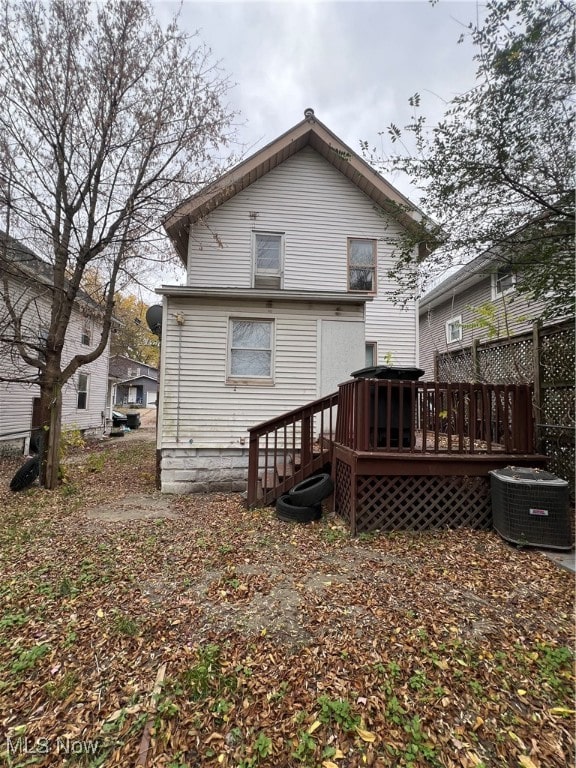 rear view of house featuring central AC and a wooden deck