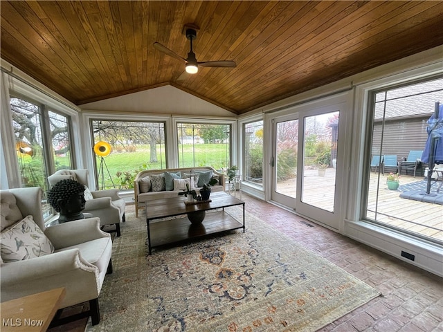 sunroom with ceiling fan, wooden ceiling, and vaulted ceiling