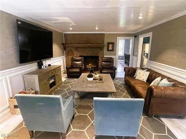 living room with crown molding and a brick fireplace