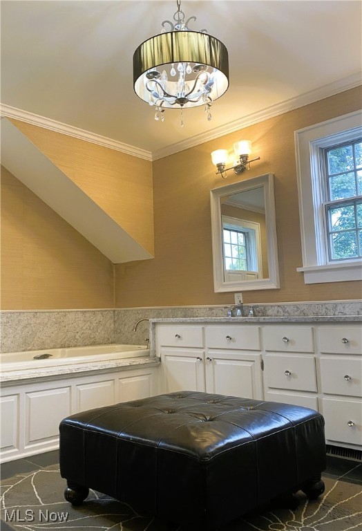 bathroom with tile patterned floors, an inviting chandelier, and ornamental molding