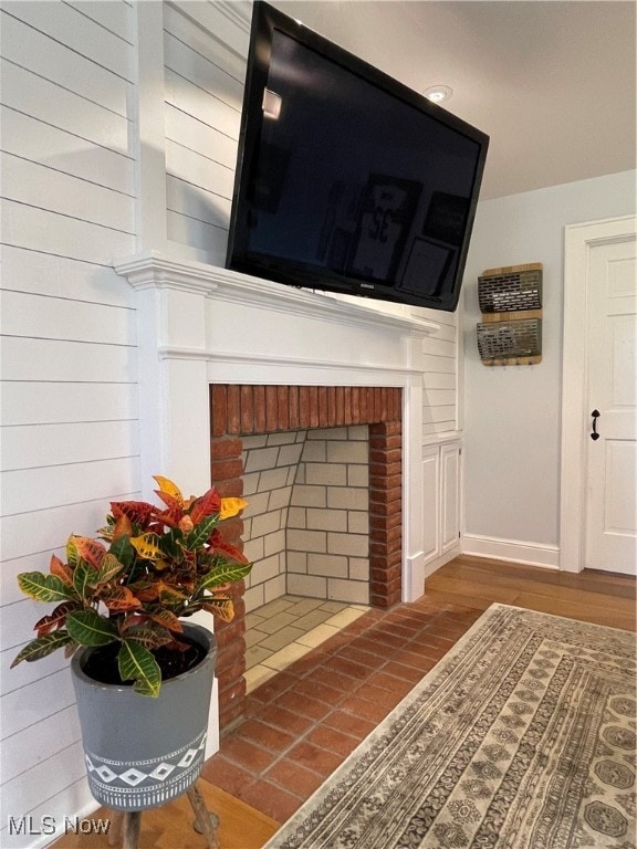 interior details featuring a brick fireplace