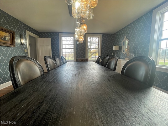 dining room featuring wood-type flooring and a wealth of natural light