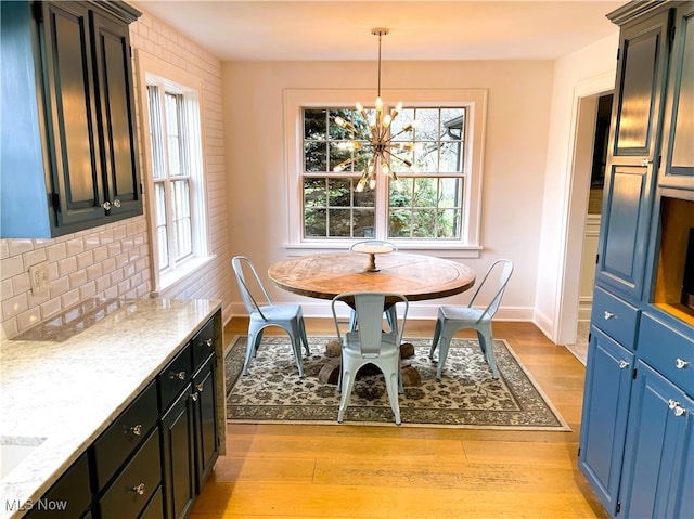 dining area featuring a chandelier and light hardwood / wood-style floors