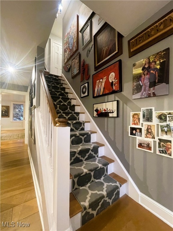 stairway featuring hardwood / wood-style floors