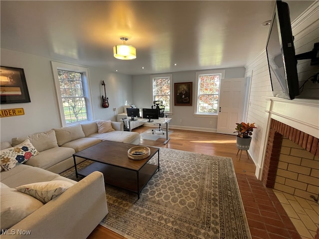 living room featuring a fireplace, hardwood / wood-style flooring, and a wealth of natural light