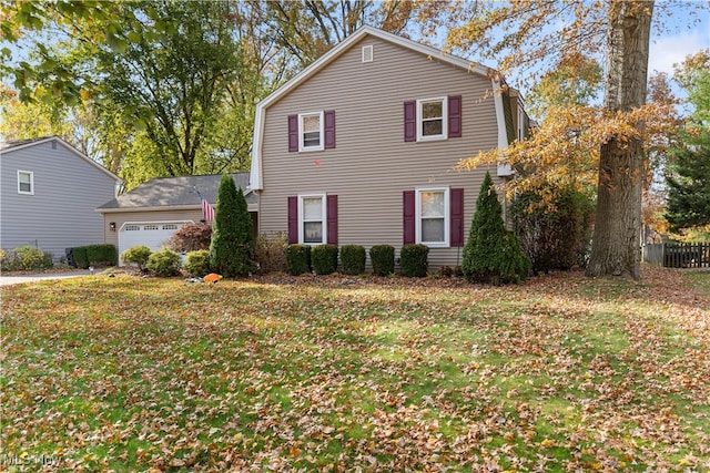 view of front property with a front yard and a garage