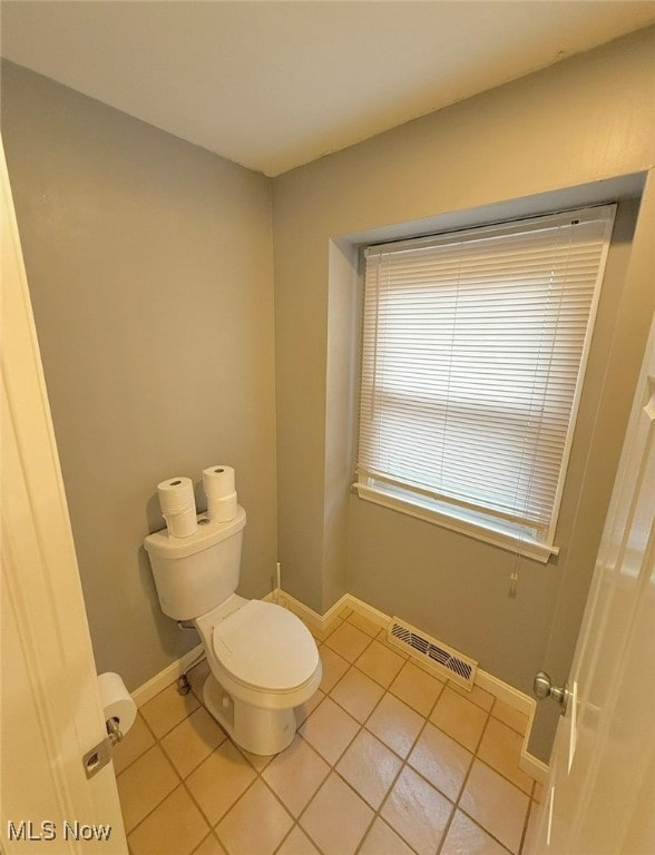 bathroom featuring toilet and tile patterned floors