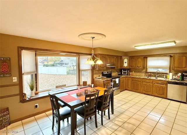 dining area featuring light tile patterned flooring, an inviting chandelier, and sink