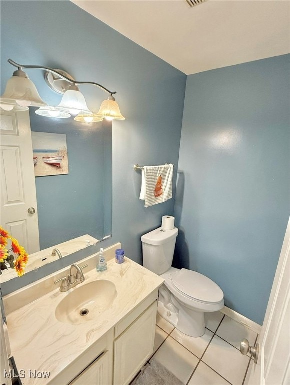 bathroom featuring vanity, toilet, and tile patterned flooring