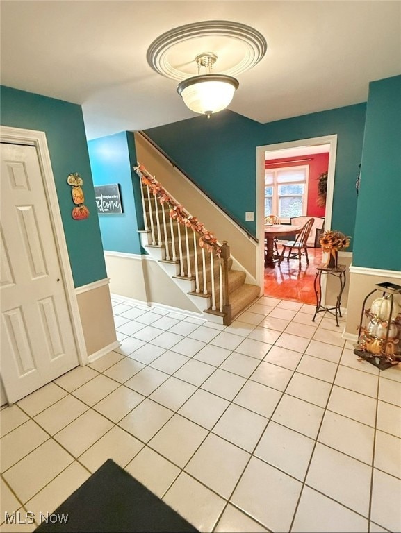 stairs featuring tile patterned floors