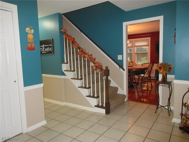 stairway featuring tile patterned flooring