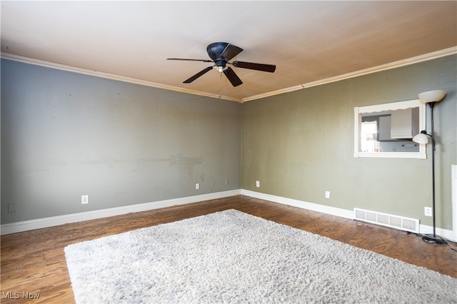 empty room with ornamental molding, wood-type flooring, and ceiling fan