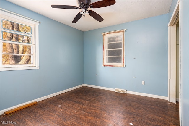 empty room featuring dark hardwood / wood-style floors and ceiling fan