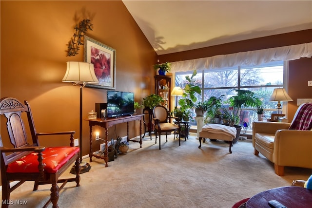 sitting room featuring light carpet and lofted ceiling