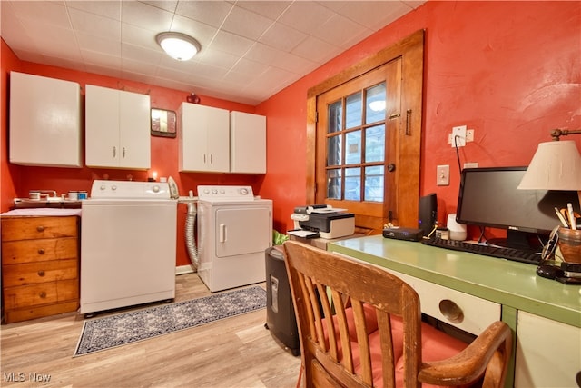 clothes washing area featuring washer and dryer, cabinets, and light wood-type flooring