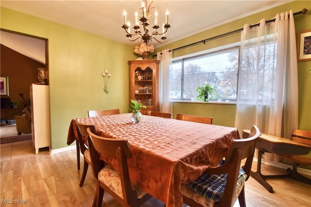 dining room featuring a chandelier and light hardwood / wood-style floors