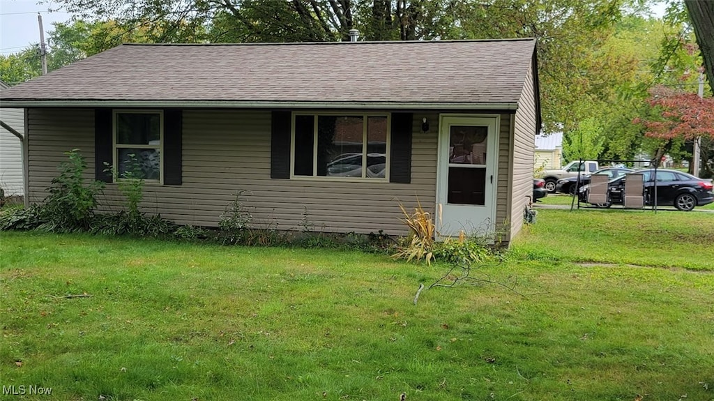 bungalow-style home featuring a front yard