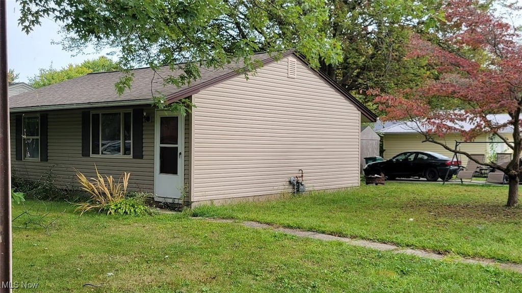 view of property exterior with a lawn