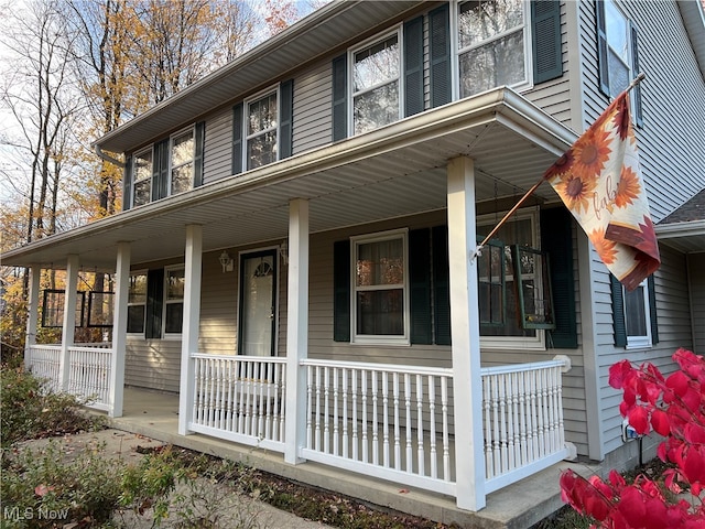 view of side of property with covered porch