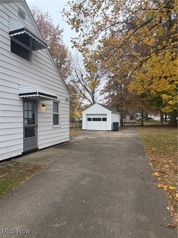 view of home's exterior with an outdoor structure and a garage