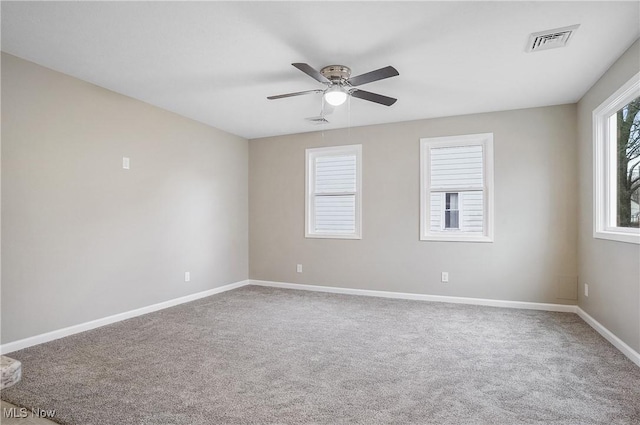 empty room featuring carpet flooring and ceiling fan