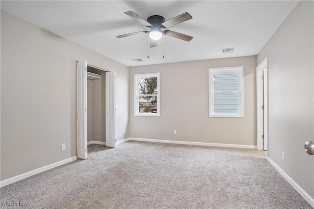 unfurnished bedroom with ceiling fan and light carpet