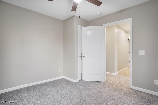 unfurnished bedroom with ceiling fan and light carpet