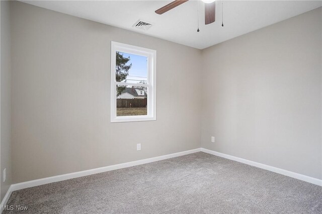 carpeted empty room featuring ceiling fan