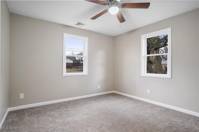 carpeted empty room featuring ceiling fan