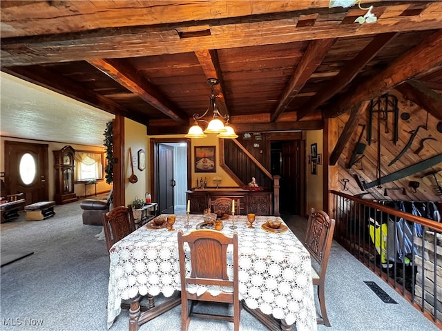 carpeted dining space with a chandelier, beamed ceiling, and wood ceiling