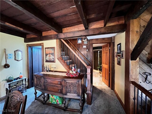 hall with stairway, wood ceiling, carpet, and beam ceiling