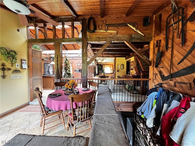 dining room with beam ceiling and wood ceiling