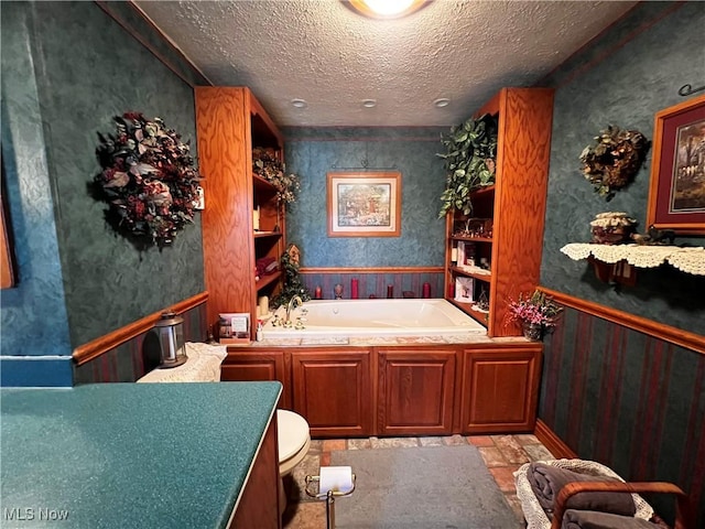 bathroom with a textured ceiling and a bathtub