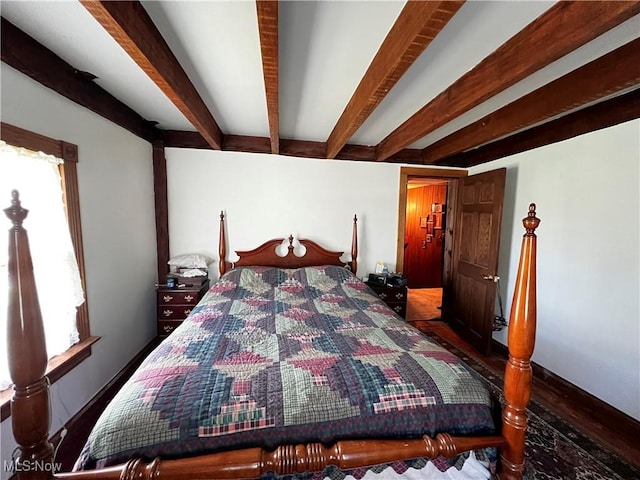 bedroom with beamed ceiling and multiple windows