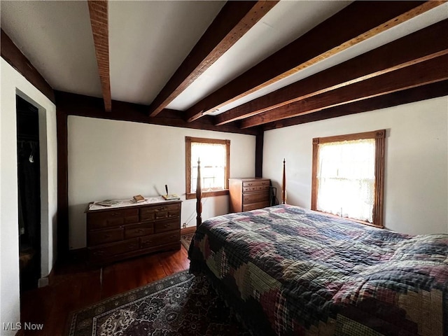 bedroom featuring dark hardwood / wood-style floors and beamed ceiling